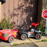 AOFOTO 7x5ft Childhood Baby Car Backdrop Street Children Toy Car Photography Background Kindergarten Driving Traffic Safety Stop Sign Outside Road Security Kid Play Game Roadblock Photo Studio Props