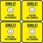 (Set of 4) Smile You’re On Camera Signs – 5″ x 5″ Self Adhesive Vinyl Decal – Indoor & Outdoor Use – UV & Weather Proof – Reflective